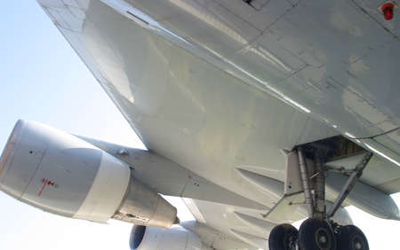 detail of a underneath plane wing and turbine 