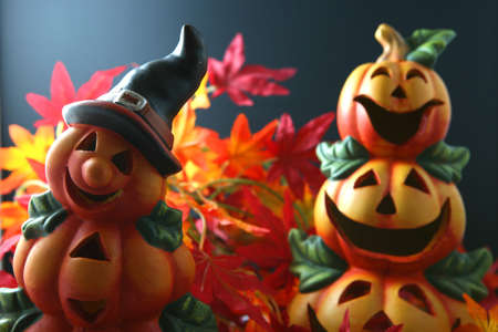 halloween pumpkin lanterns with red and orange colored autum leaves