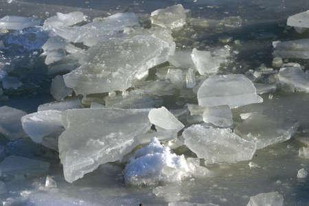 deeply frozen lake in wintertime in bright sunlight