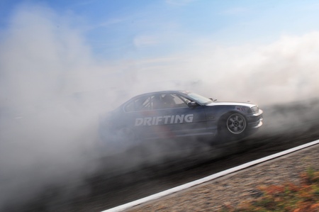PREJMER, ROMANIA - SEPTEMBER 18 2011: BMW E36 in smoke at King of Europe 2011 drifting eventのeditorial素材