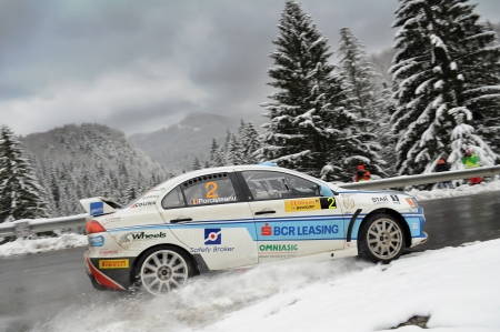 BRASOV, ROMANIA - MARCH 21 2013: Vali Porcisteanu/Dan Dobre racing a Mitsubishi Lancer EVO X R4 at TESS Rally Brasov 2013のeditorial素材