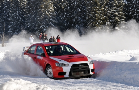 COMANDAU, ROMANIA - JANUARY 28 2012: Winner of the rally Szabo Gergo with a Mitsubishi EVO X at Comandau Rally 2012のeditorial素材