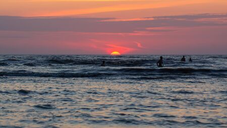 People at the Evening Beach at Sunset Time.