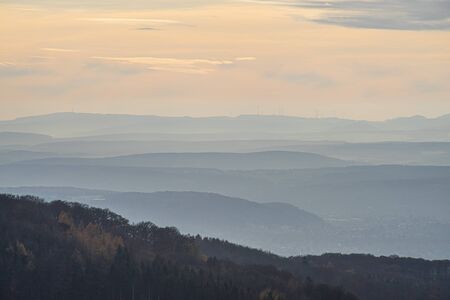 View over the hills at river Rhine in the light of an autumnal late afternoon sun.の写真素材