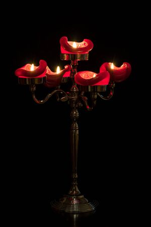 Candelabra with five candles on a table.の写真素材