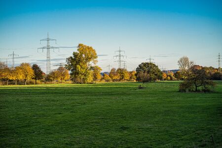 Electricity pylons over the Auwiesen on the river Sieg.の写真素材
