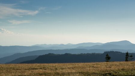 View from a meadow on the Feldberg over hazy hills.の写真素材