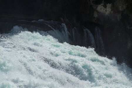 The roaring waters of the Rhine Falls near Schaffhausen going over the edge.の写真素材