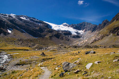 Way up to a small glacier in the high mountains, melted by climate change. A summer picture.の写真素材