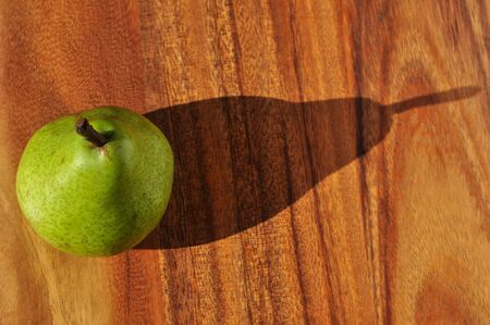 Pear with Shadow on Cutting Boardの写真素材