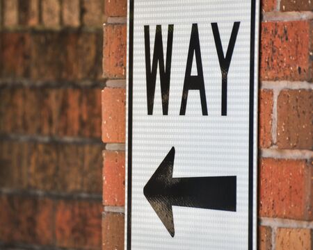 Sign with Arrow on Brick Wallの写真素材