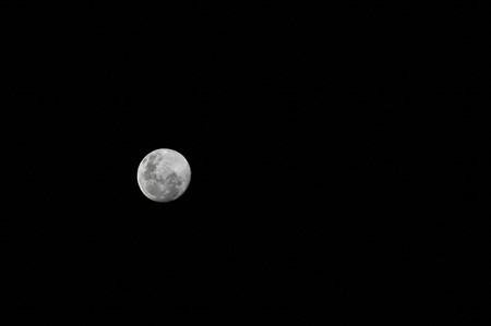 A full moon in a starless night sky