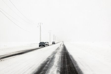 Slow traffic on snow storm on national road, Romaniaの写真素材