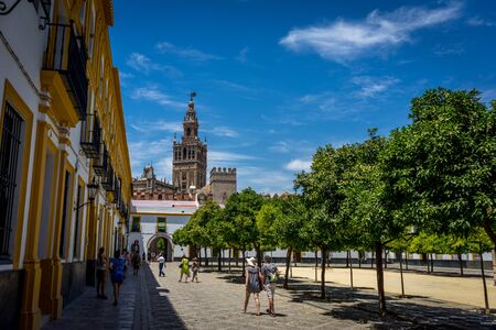 The Giralda Bell tower with people in the foreground in Seville, Spain, Europeの写真素材
