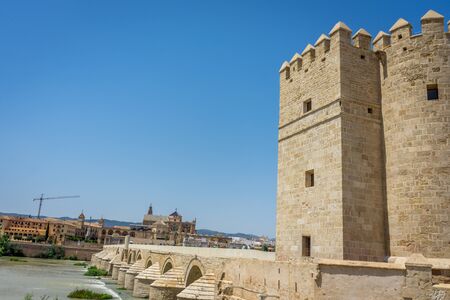 A view of the Calahorra tower, roman bridge and the Mezquita de Córdoba,the Great Mosque of Córdoba, Mosque-Cathedral,Mezquita and bell tower from the bridge on river Guadalquivirの写真素材
