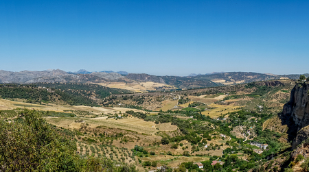 Greenery, Mountains, Farms and Fields on the outskirts of Ronda Spain, Europe on a hot summer day with clear blue skiesの写真素材