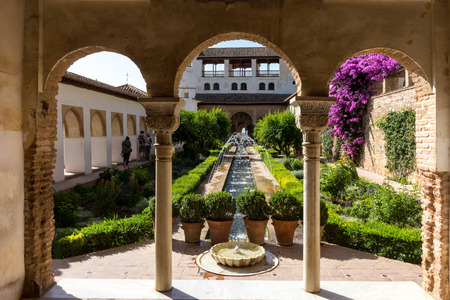 View of The Generalife courtyard, with its famous fountain and garden through an arch. Alhambra de Granada complex at Granada, Spain, Europe on a bright summer dayのeditorial素材