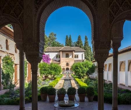View of The Generalife courtyard, with its famous fountain and garden through an arch. Alhambra de Granada complex at Granada, Spain, Europe on a bright summer dayのeditorial素材
