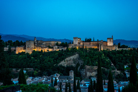 The magnificient Alhambra of Granada, Spain. Alhambra fortress at sunset viewed from Mirador de San Nicolas during evening twilight hour.のeditorial素材