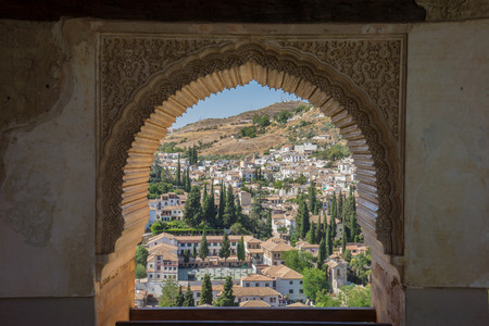 View of the Albayzin district of Granada, Spain, from a window in the Alhambra palace near sunset at Granada, Spain, Europe on a bright sunny dayの写真素材