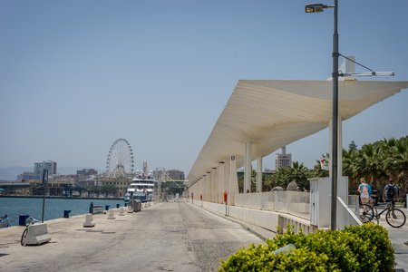 A giant wheel alongside the beach in Malaga, Spain, Europe on a bright summer morningのeditorial素材