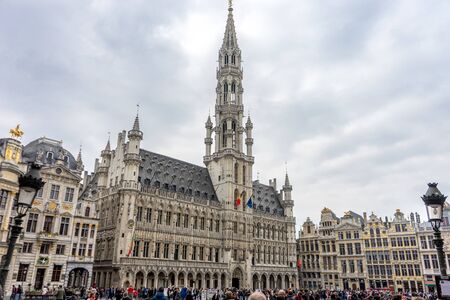 The palace of Brussels illuminated at day in market square at Brussels, Belgium, Europe on a cloudy day with gray skyのeditorial素材