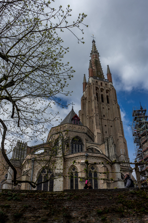 The Church of our lady in Brugge, Belgium, Europe on a bright summer day with blue skyのeditorial素材