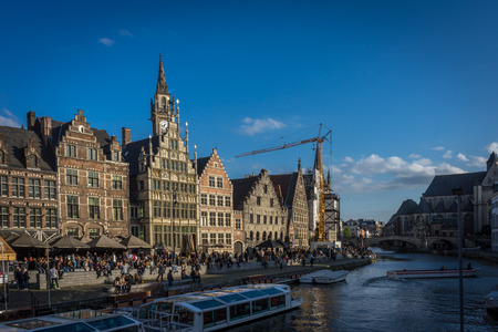 Leie river bank in Ghent,Belgium,Europe on a bright sunny day with blue sky