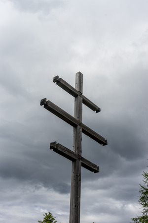 Alpe di Siusi, Seiser Alm with Sassolungo Langkofel Dolomite, a wooden pole in a cloudy skyの写真素材