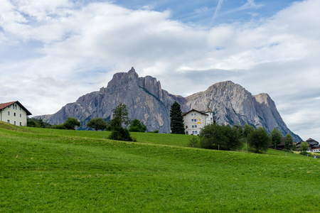Kastelruth, Italy - 29 June 2018: The parc hotel Tyrol in town of Kastelruth, Castelrotto in Italy with dolomite backgroundのeditorial素材
