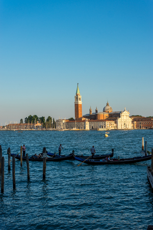 Venice, Italy - 30 June 2018: Gondolas moored by Saint Mark square with San Giorgio di Maggiore church in the background in Venice, Italyのeditorial素材