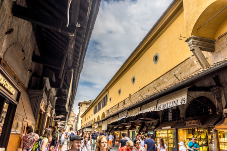 Florence, Italy - 25 June 2018: Tourists walking over the Ponte Vecchio bridge over the Arno River in Florence, Italyのeditorial素材