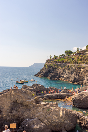 Manarola, Cinque Terre, Italy - 27 June 2018: Tourists enjoying the beach and sunshine at Manarola, Cinque Terre, Italyのeditorial素材