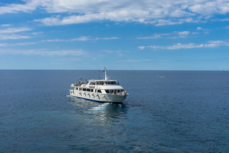 Riomaggiore, Cinque Terre, Italy - 26 June 2018: Tourists boat on the ocean overlooking Riomaggiore,...