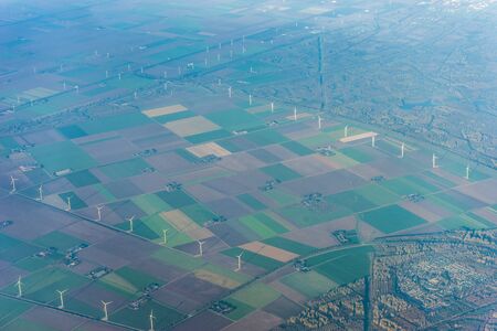 Amsterdam Schiphol,, a large stadium with green grass windmill farm