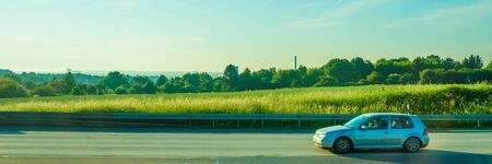 Germany, Frankfurt, Sunrise, Outkirts, a car parked on the side of a roadの写真素材