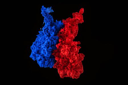 Swirls of colorful ink under water on black backgroundの写真素材