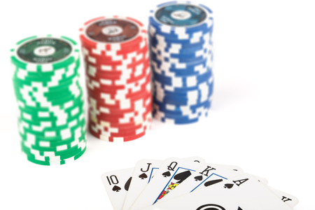 Casino chips and playing cards on white background
