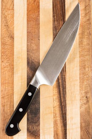 Chef's knife on cutting board. Big cook's knife