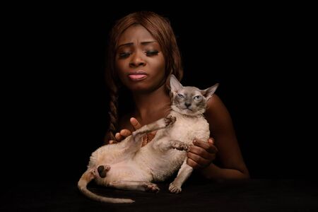Lazy weary cat and owner. Animal castration. Studio. Pleased cat