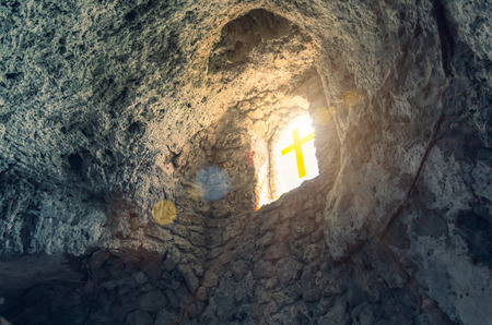 Silhouette of the cross at the window in caveの写真素材