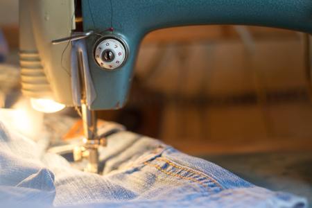 Sewing jeans on the sewing machine.の写真素材