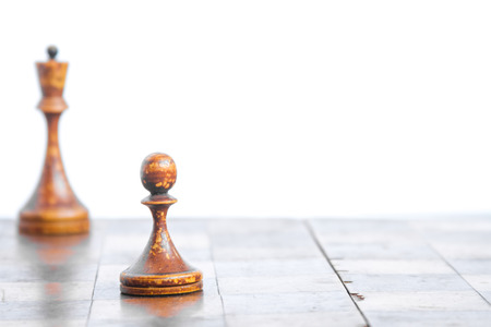 Old chess Board with wooden pieces on a white background.の写真素材