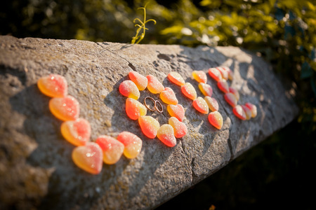 The inscription "love" from the marmalade and wedding rings on a stone fence of the old castle.の写真素材