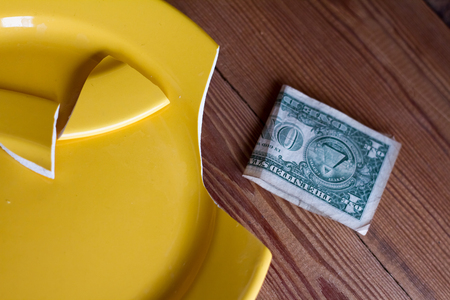 broken yellow plate - diet or crisis.の写真素材