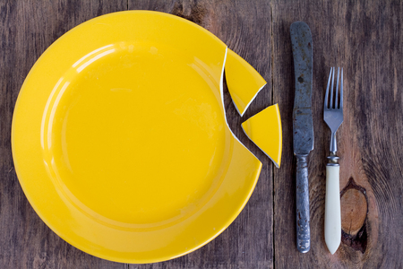 broken yellow plate - diet.の写真素材