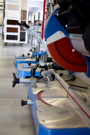 Men at work sawing wood. Circular saw. A machine which saws wood, particle Board and fiberboard.の写真素材