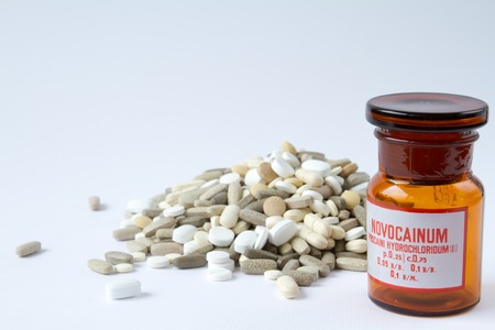Colorful medical pills in a glass container on a white background.の写真素材