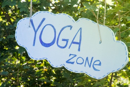 Inscription Yoga Zone on a background of green tree.の写真素材