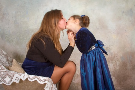 Mother And Daughter Relaxing Together In Chairの写真素材